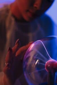 a close up on female touching plasma ball