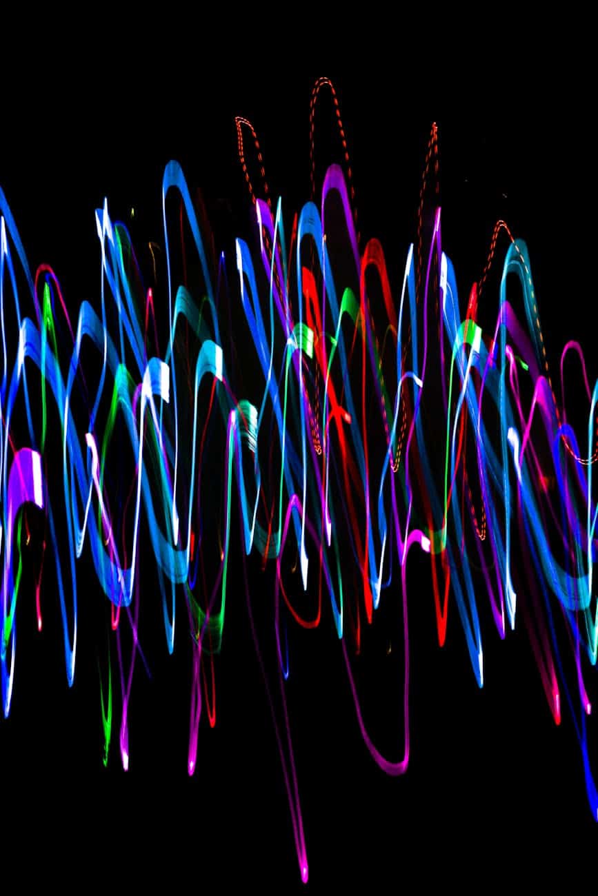 overlapping neon sound waves on black background